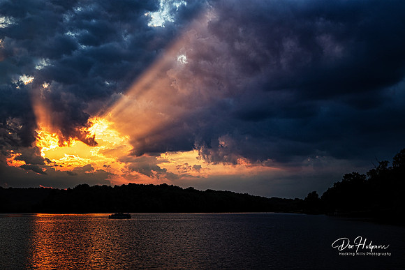 Dramatic Rays of Sunlight Illuminate the Clouds at Lake Logan, Hocking Hills, Ohio by Don Holycross of Hocking Hills Photography, Logan, Ohio